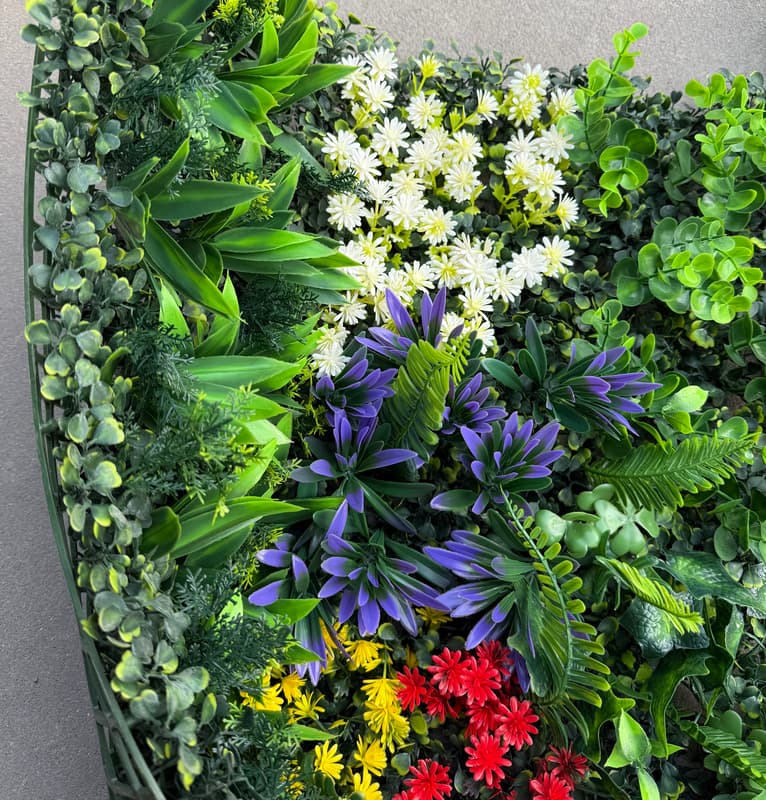 Side view of 20x20 artificial greenery wall panel showing thick layered foliage and dimensional depth