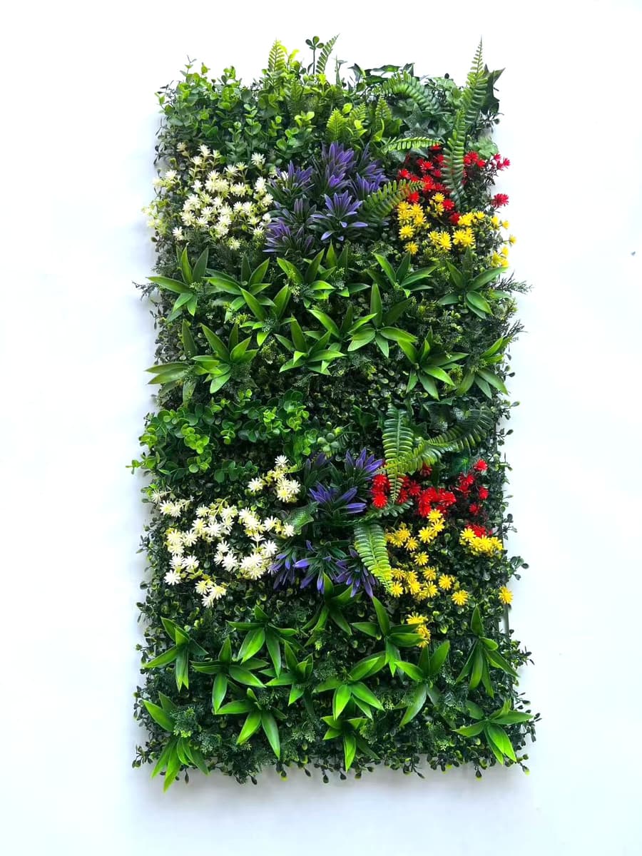Multiple 20x20 artificial greenery wall panels connected to form a vibrant multi-tone foliage wall with leaf-based color variation