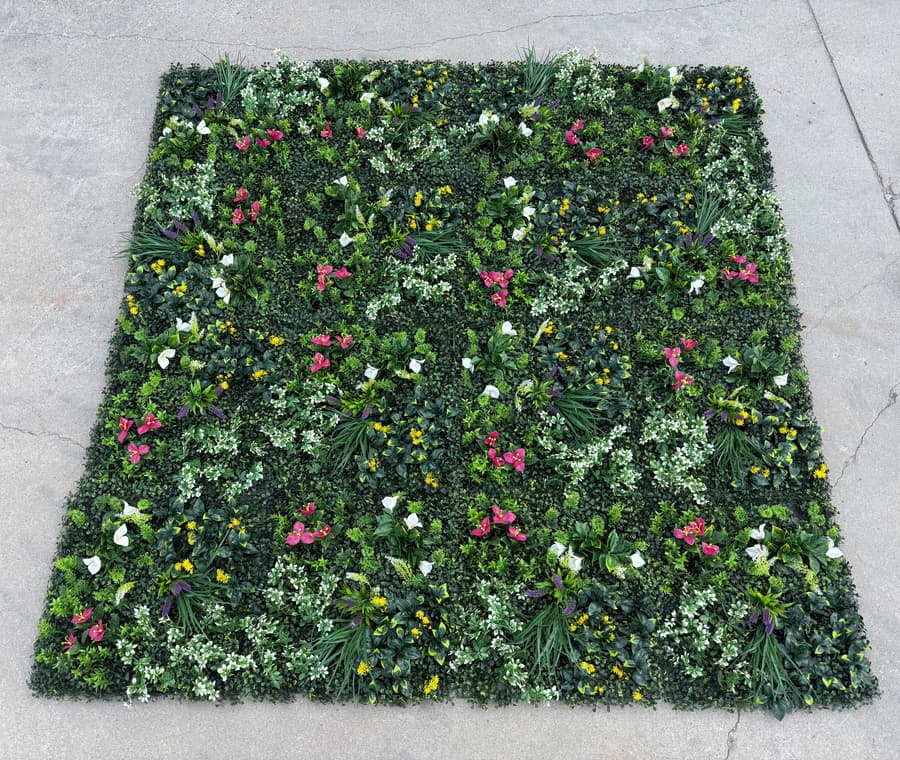 Multiple 20x20 floral greenery wall panels connected to form a seamless decorative backdrop with flower accents